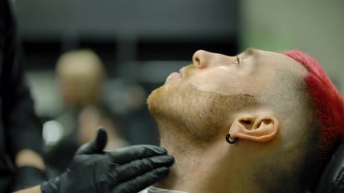 Professional Barber wird mit einem speziellen Rasiergel auf einen Kunden aufgetragen