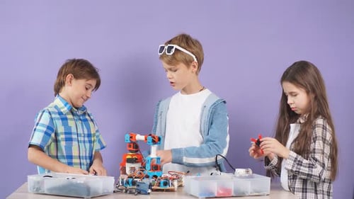 Kids Interested in Robotics, Try To Assemble and Create New Robot Together