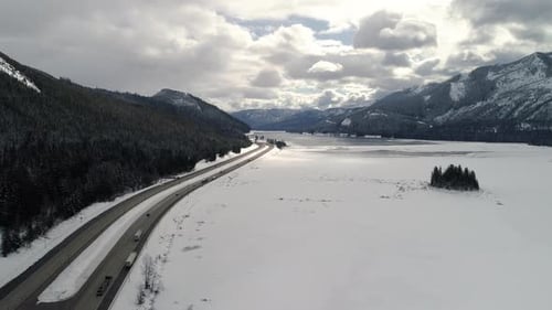 Epic Snowy Environment Freeway Transportation Aerial Over Frozen Lake