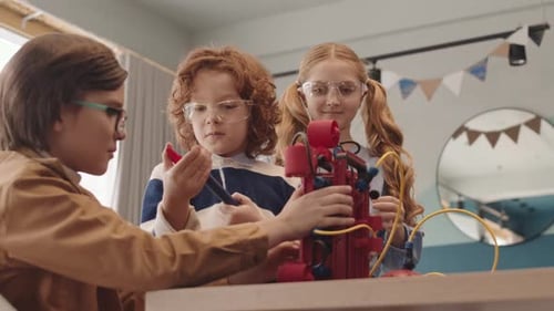 Three Classmates Constructing Robot during Lesson