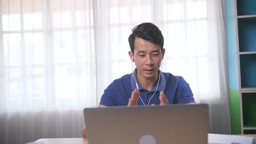 Young Adult Working Remotely from Home Office