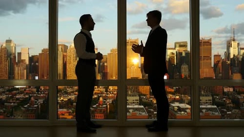 Male Managers Meeting in Modern City Office Chatting on Finance Deal