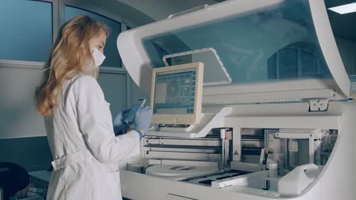 Lab Technician Using Machine in Hospital Laboratory