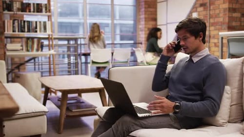 Creative businessman using laptop in modern office