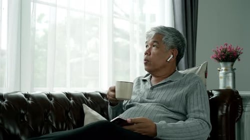 Elderly Asian Using Modern Gadgets