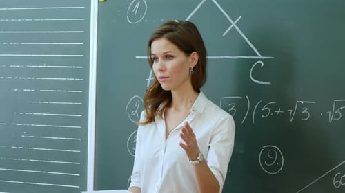 Young Adult Woman Explains Math in Classroom