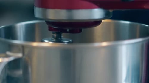 Mixer Gradually Spins in Big Metal Bowl to Prepare Cream