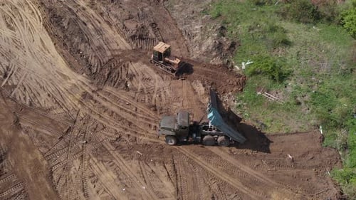 Bulldozer and Dump Truck Moving Dirt, Aerial