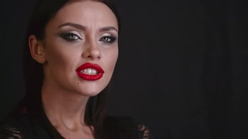 Glamourous Woman Posing with Bright Red Lipstick