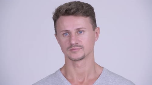 Face of Handsome Bearded Man Thinking Against White Background