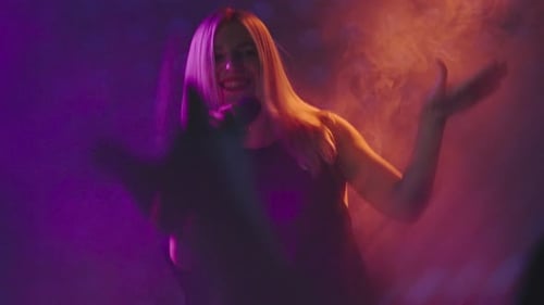 Singer Performing Energetically on Stage at Night