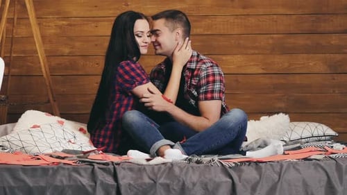 Affectionate Couple Embracing on Bed Indoors