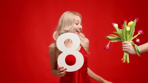 Woman Receives Flowers and Number Eight Decoration