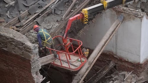 Demolition of Old Abandoned House Workman in Orange Helmet at Crane Basket Destroy Wooden Roof with