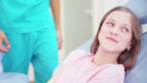 Child Patient Holding Hands at Dentist Office