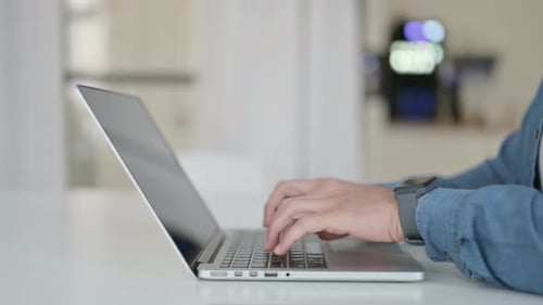 Hands of Man Typing on Laptop