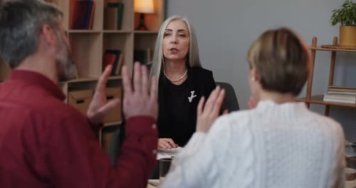 Front View of Female Psychologist Calming Down Married Couple That Shouting on Each Other