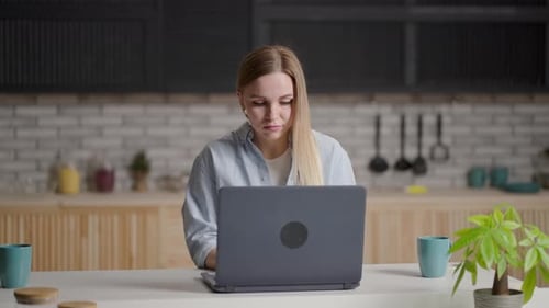 Concentrated Focused Woman Student or Freelancer Working at Laptop in Cafe or Coworking