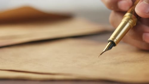 Detail Shot of Man Hand in Fountain Pen Writing or Signature on Paper