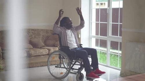 Man Celebrates in Wheelchair with Upbeat Dancing
