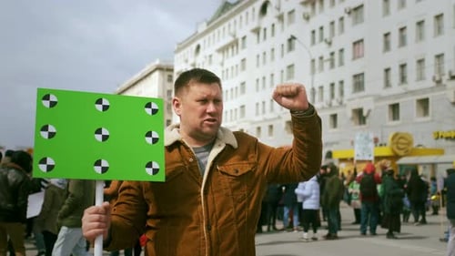 Riot Activist Holds Green Chroma Key Banner