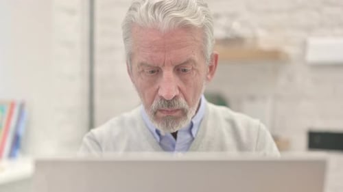 Close Up of Old Man Working on Laptop