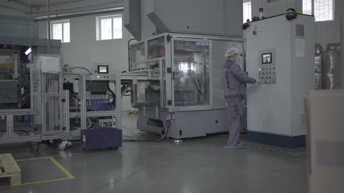 Factory Worker Operates Advanced Industrial Equipment