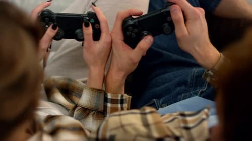Young Adults Playing Video Games on Couch Close Up