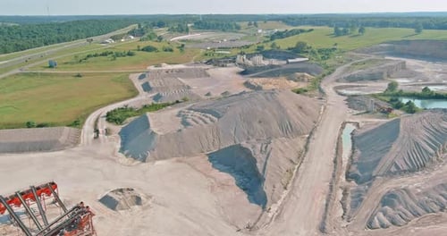 Aerial View of Open Cast Mining Panorama Quarry with Lots of Machinery at Work Equipment at a Plant