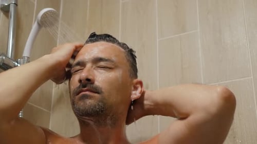 Man Shampooing Hair in Bathroom Shower