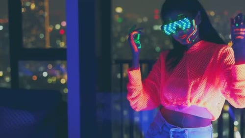 Neon asian woman dancing. Fashion model woman in neon light,