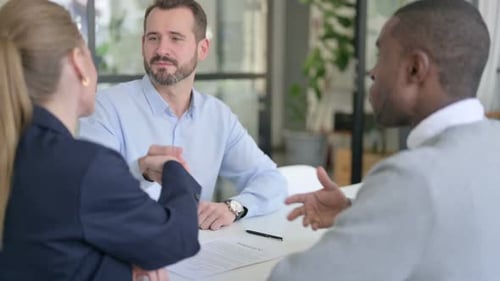 Successful Mixed Race Business People Shaking Hands in Office