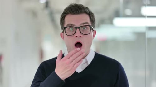 Man Reacting to Shocking News in the Office