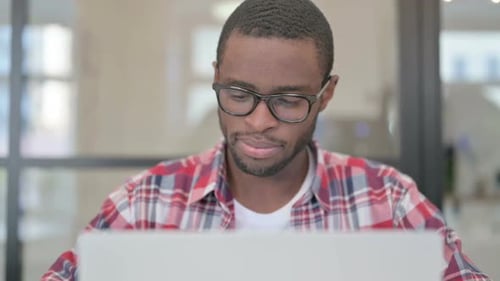 Close Up of African Man Working on Laptop