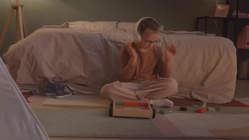 Girl Listening to Music and Playing in Bedroom