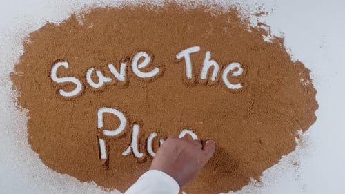 Save The Planet Message Written in Brown Powder