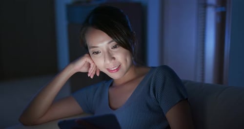 Woman use of tablet at night