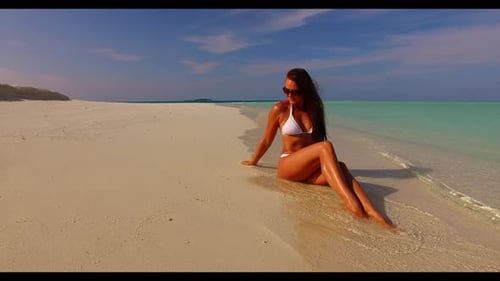 Woman tanning on relaxing coastline beach wildlife by blue sea and white sand background of the Mald