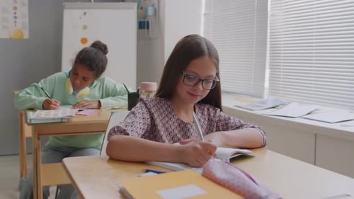 Students Working Diligently at Desks in Classroom