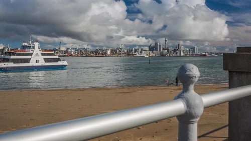Coastal Cityscape with Passenger Boat on a Cloudy Day
