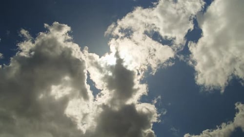 Timelapse of Fluffy Clouds Passing Sun in Blue Sky