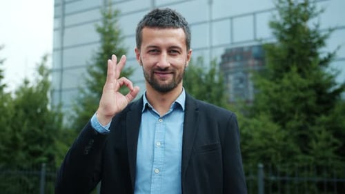 Young Adult Man Gives OK Hand Gesture