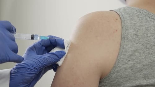 Medical Injection in Arm by Healthcare Worker