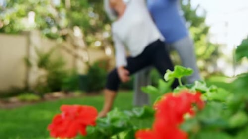 Yoga Instructor Helping Senior Woman With Exercise