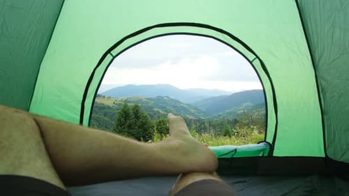 The Guytourist Has a Rest Lying in a Tent a Beautiful View From a Tent on Mountains Summer Time
