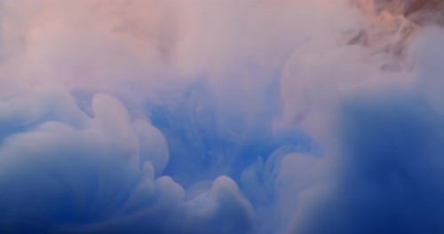 Macro Close-up Watercolor Blue and Orange Ink Spreads in Water, Colored Smoke Stream Spreading