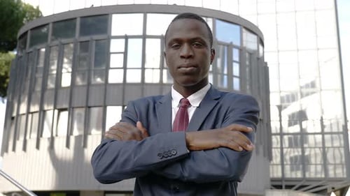 Confident Adult in Suit With Arms Crossed
