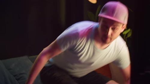 Man Playing Video Game on Couch at Night