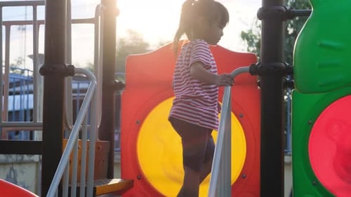 Children Playing on Playground Equipment on Sunny Day