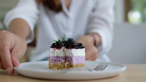 Woman Eating Decadent Blueberry Cake at Home